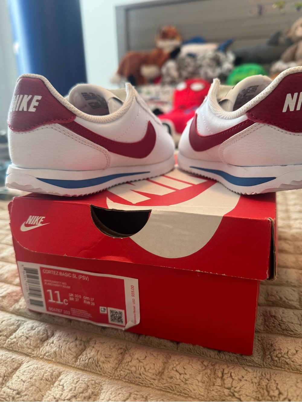 Nike Kids White Sneakers with Red Swoosh and Blue Midsole Accent